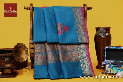 Banarsi Handloom Pure Tussar Saree with All Over Woven Motifs and Woven Zari Border. The Palla is  Woven Zari. It comes with Self Colored Tissue Unstitched Blouse with Zari Border. Perfect for Formal Wear.  Recommended for Autumn & Winter season(s). Dry Clean Only