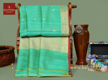 Banarsi Handloom Pure Tussar Saree with All Over Woven Motifs and Woven Zari Border. The Palla is  Woven Zari. It comes with Self Colored Woven Unstitched Blouse with Woven Border. Perfect for Formal Wear.  Recommended for Autumn & Winter season(s). Dry Clean Only